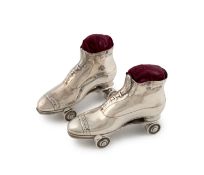 A pair of Edwardian silver novelty roller skate pincushions,