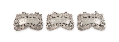 A set of three George IV silver 'singing foxes' wine labels,