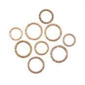 A COLLECTION OF NINE 19TH CENTURY GOLD AND BASE METAL SPLIT RINGS
