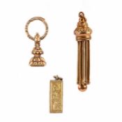 TWO CHARMS AND A GOLD FOB SEAL