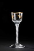A GILT DECORATED WINE GLASS