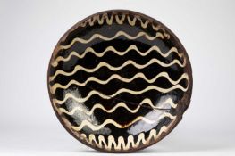 A STAFFORDHSIRE SLIPWARE DISH