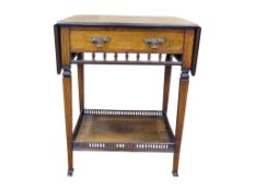 An Edwardian rosewood drop leaf side table raised on square tapered supports enclosing a frieze