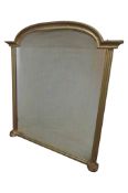 A contemporary antique style overmantel mirror with moulded arch frame and split column supports,