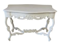 A painted side table on shaped supports with foliate detail, 76 cm high x 103 cm x 56 cm