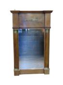 An early 19th century mahogany mirror with column supports and brass detail. 88cm x 55cm.