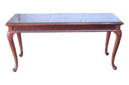 A reproduction cabriole leg side table with blind fretwork frieze beneath a plate glass top, 68cm