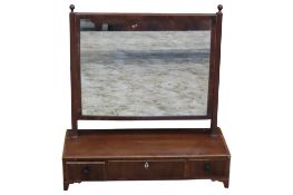 A Regency mahogany toilet mirror of rectangular form with reeded supports and box base enclosing