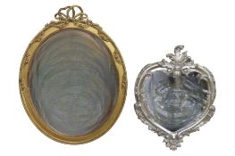 An oval gilt framed wall mirror with tied ribbon surmount, 76 cm x 59 cm together with a further