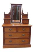 An Edwardian mahogany dressing chest with a raised mirror back. 65cm height, 105cm width, and 50cm
