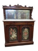 A Regency rosewood chiffonier enclosed by a pair of panel doors with tapestry panel, set beneath a