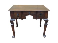 A 19th Century side table, principally in walnut with three drawers to a centre kneehole, set on
