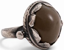 A scarce 17th century silver-mounted amuletic toadstone ring, set with a smooth, domed brown