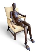 A rare and impressive life-size wooden artist's lay figure or manikin of the female form, fully