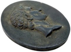 A Wedgwood black basalt plaque of oval form, moulded in relief with a profile bust of the Roman