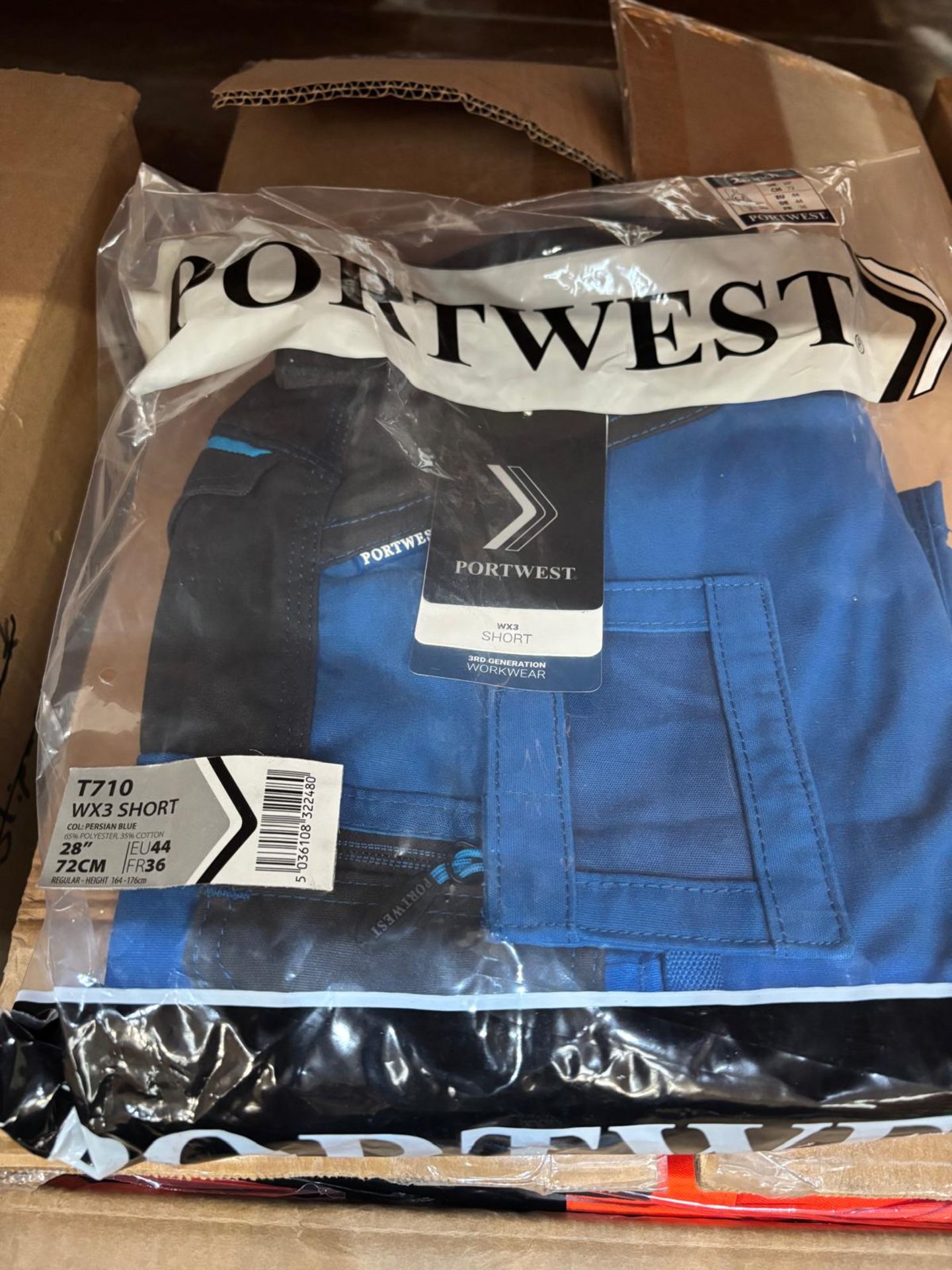 7 X NEW PACKAGED PORTWEST T710 WX3 SHORTS. PERSIAN BLUE. SIZE 28" (LOC: 4.6-ZB96)