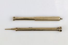 An antique yellow metal combination dip pen and propelling pencil, with reeded body, and