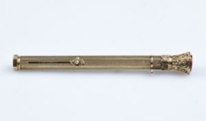 An antique yellow metal propelling combination pencil and dip pen, with engine turned barrel,
