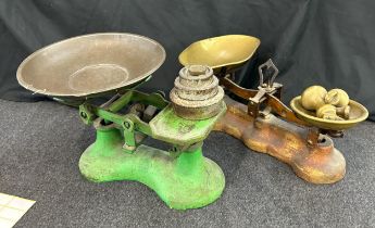 Two vintage cast iron balance scales with assorted weights