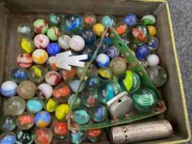 Collection of vintage marbles in an old advertising tin