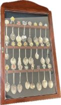 Vintage wooden glazed wall hanging collectors spoon display cabinet containing 22 assorted