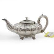 A silver melon shaped teapot