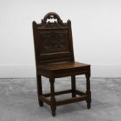 A carved oak panel-back chair In the 17th century style