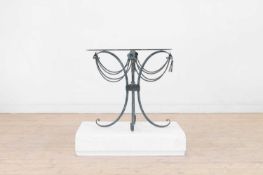 A Hollywood Regency glass and patinated-metal occasional table,