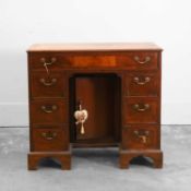 A George III mahogany kneehole desk 20th century