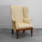 A mahogany wingback chair Victorian