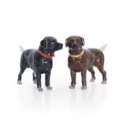 A pair of black and brown coated metal figures of dogs 21st century