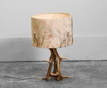 An antler table lamp with stag-print shade, Of recent manufacture