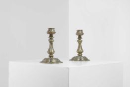 A pair of small brass candlesticks Of recent manufacture