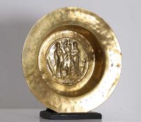 A brass alms dish with repoussé Adam and Eve medallion 16th century