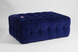 A contemporary blue upholstered ottoman Modern