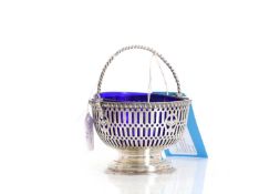 A silver swing handled sugar bowl