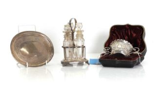 A silver three bottle cruet stand