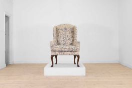 A Queen Anne-style walnut wing armchair 19th century