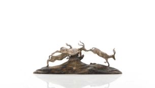 A silver and wood model of leaping impalas By Patrick Mavros, Zimbabwe, 20th century