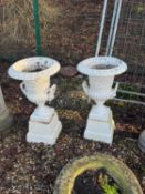 A pair of cast iron garden urns and stands Antique