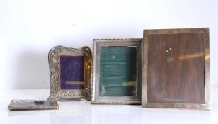 A group of four silver photograph frames,