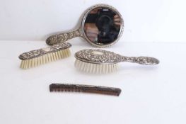 A collection of silver handled brushes,