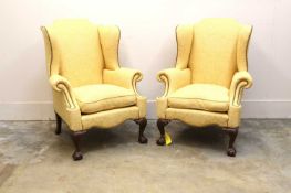A pair of yellow damask upholstered wing-back armchairs, late 19th century,