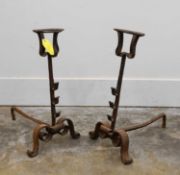 A pair of wrought iron fire dogs, probably 18th century,