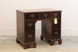 A George III crossbanded mahogany kneehole desk,
