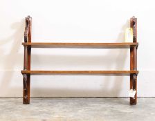 A mahogany wall hanging shelf, 20th century, in the Regency style,