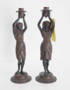 A pair of cold-painted cast metal figural candlesticks, Circa 1900,