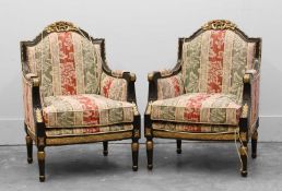 A pair of ebonised and parcel gilt bergère arm chairs, late 19th / early 20th century,