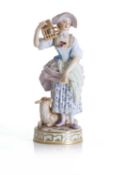 A Meissen figure of a shepherdess holding a birdcage with a lamb, 19th century,