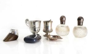 A silver christening mug,